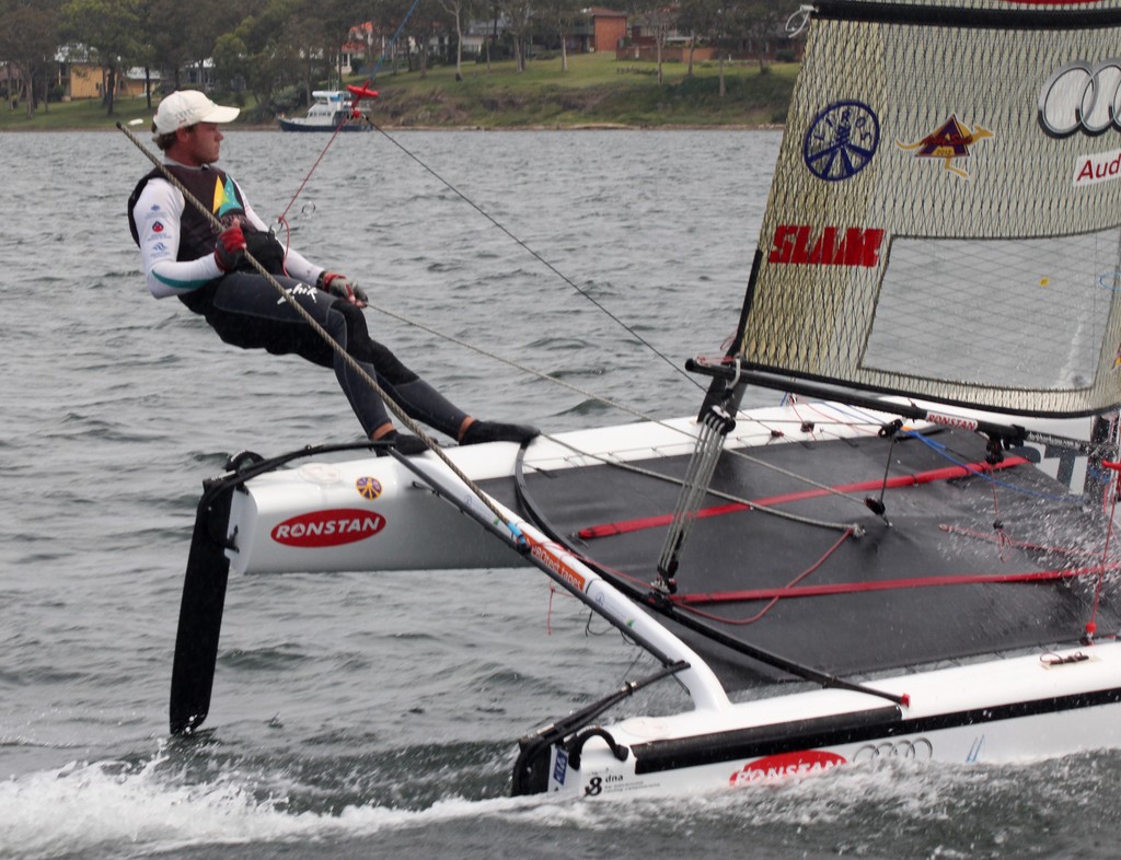 Nathan Outteridge trapezing down-wind ©  SW